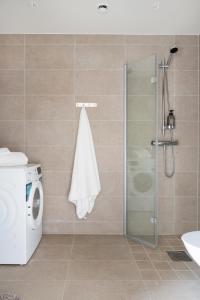 a bathroom with a shower and a washing machine at Luxurious apartment in central Grebbestad! in Grebbestad