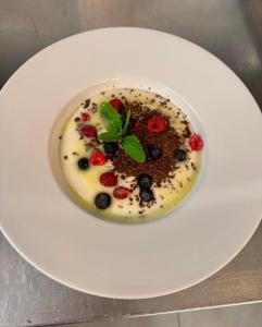 a dessert on a white plate on a table at GREEN HOTEL Ostrava in Jáma František +4 photos