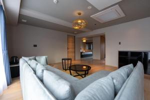 a living room with a couch and a table at The 1898 Niseko in Kutchan +20 photos