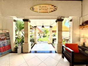 a lobby of a house with columns and a clock at Mamo Hotel Uluwatu in Uluwatu
