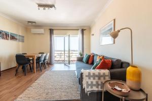 a living room with a couch and a table at Ericeira Beach Apartment in Ericeira