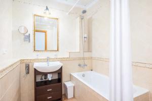 a bathroom with a sink and a tub and a mirror at Ca na Lluny in Artá +8 photos