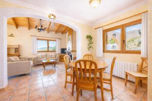 a living room with a table and chairs and a couch at Ca na Lluny in Artá