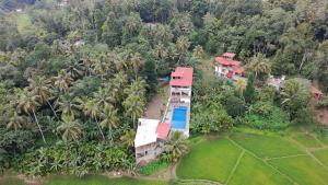 an aerial view of a resort with palm trees at The Secret Place Hotel & Resort in Kandy