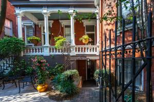 a house with potted plants on a balcony at Kehoe House, Historic Inns of Savannah Collection in Savannah