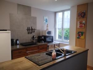 a kitchen with a sink and a dish rack at En passant par La Maraude in Vigneulles-lès-Hattonchâtel
