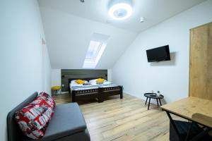 a living room with a bed and a couch at Birdhouse in Prešov