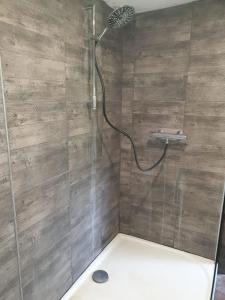 a shower with a glass door in a bathroom at Domaine de La Siaule in Saint-Germain-dʼAunay