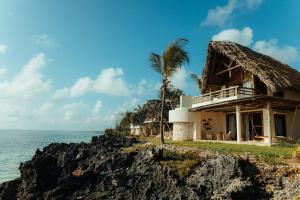 a house on a cliff next to the ocean at Matemwe Attitude - Adults Only in Matemwe