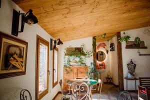 a dining room with a table and a wooden ceiling at La Cata Country House in Patones