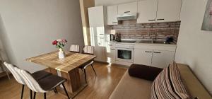 a kitchen with a table and chairs and a kitchen with a sink at Apartments Sime in Sukošan