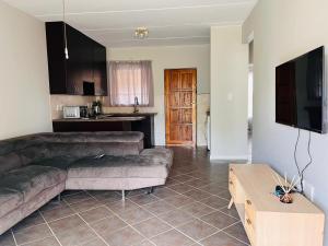 a living room with a couch and a table at Honeypot Ridge 29 in Honeydew +10 photos