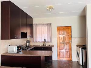 a kitchen with a sink and a counter with a microwave at Honeypot Ridge 29 in Honeydew
