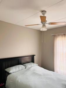 a bedroom with a ceiling fan and a bed at Honeypot Ridge 29 in Honeydew