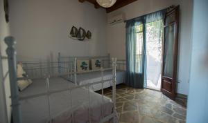 a bedroom with a bunk bed and a sliding glass door at Villa Sophia in Andros +29 photos
