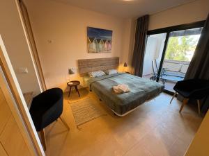 a bedroom with a bed and a large window at Sonne - Golf - 4Pers - Komfort - Apartments in Fuente-Álamo de Murcia +103 photos