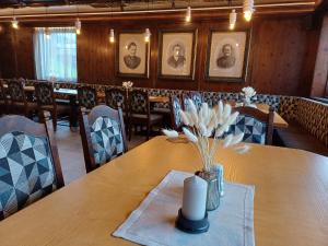 a dining room with a table with a candle on it at B&B Kaiserstube in Flachau +4 photos
