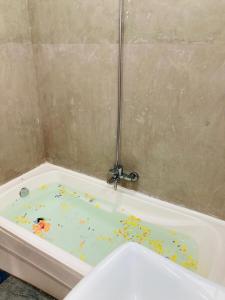 a bath tub filled with confetti in a bathroom at Emerald Mountain Resort in Ampitiya