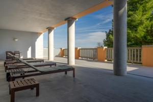 a porch with benches and columns on a building at Pousada da Serra da Estrela in Covilhã
