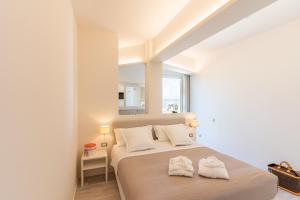 a bedroom with a bed with two towels on it at Riviera Hotel in Senigallia