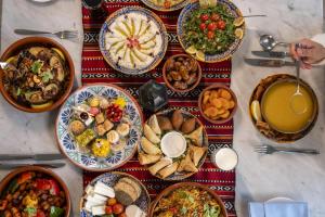 a table with many plates of food on it at Radisson Blu Hotel & Resort, Abu Dhabi Corniche in Abu Dhabi