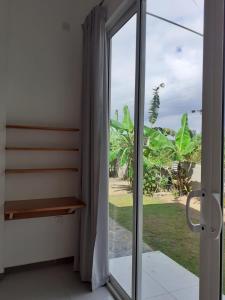a sliding glass door with a view of the ocean at Sathmani One in Nikawatawana