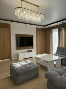 a living room with a couch and a table at Forest Club Burabay in Zhezdi