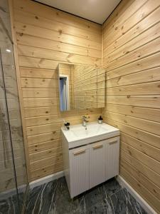 a bathroom with a white sink and a mirror at Forest Club Burabay in Zhezdi +11 photos