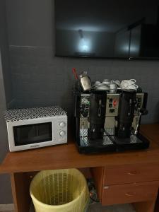 a counter with a microwave and coffee pots and pans at IL COLOSSEO B&B CASSINO in Cassino +16 photos