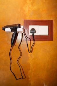 a blow dryer plugged into a wall outlet at Comfort Treehouse Pidurangala in Dambulla
