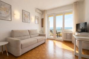 a living room with a couch and a view of the ocean at La Casa Di Gianni - Vista Mare in Ospedaletti