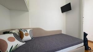 a bed with pillows on it in a room at La Casa Di Gianni - Vista Mare in Ospedaletti