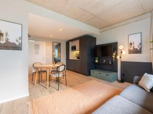 a living room with a couch and a table at Limehome Düsseldorf Stresemannstraße - Digital Access in Düsseldorf
