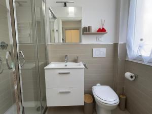 a bathroom with a toilet and a sink and a shower at La Casa Di Gianni - Vista Mare in Ospedaletti +3 photos