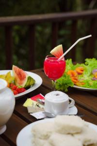 a table with two plates of food and a drink at Monsoon Cabana Ella in Ella +20 photos