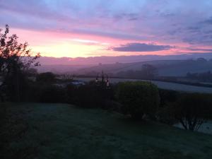 a sunset from the backyard of a house at North Hollacombe Farm in Colebrooke