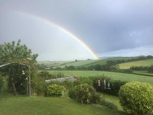 a rainbow in the sky over a yard at North Hollacombe Farm in Colebrooke