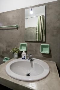 a white sink in a bathroom with a mirror at Mikio Guest House in Kalabaka +27 photos