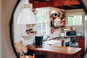a kitchen with a sink and a stove top oven at Breathe Glenrock Gardens in Tenterfield