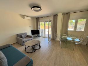 a living room with a couch and a table at Sani Luxury Pool Villa in Sani Beach