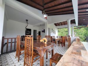a dining room with a wooden table and chairs at The Secret Place Hotel & Resort in Kandy