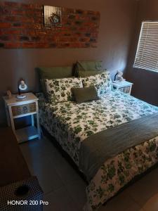 a bedroom with a bed and a brick wall at Habakkuk Guesthouse in Bethlehem