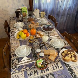 a table with food and fruit on top of it at B&B Ai Glicini Castelli Romani in Marino +36 photos