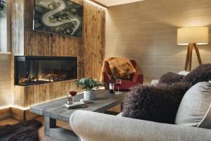 a living room with a couch and a fireplace at Scar View - Getaway for Two - Ridgestone in Underbarrow