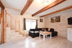 a living room with a black couch and a table at Drevenica Matilda in Pribylina