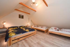 a bedroom with two beds in a attic at Drevenica Matilda in Pribylina