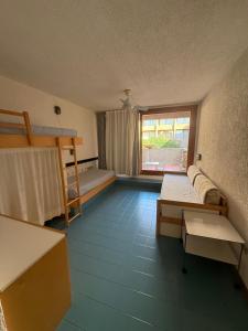 a room with two bunk beds and a couch at Cugnana Verde Vacanze in Olbia