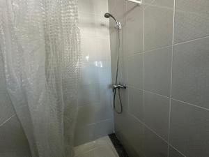 a shower with a shower curtain and a toilet at La Marquesa - CA L'ONA in Poblenou del Delta +14 photos