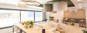 a living room with a white couch and a table at Canvas Sabadell Llac in Sabadell