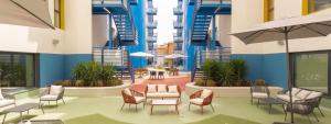 a lobby with chairs and tables in a building at Canvas Sabadell Llac in Sabadell